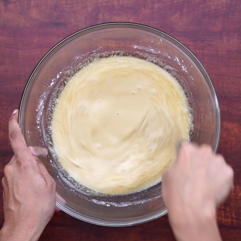 adding egg and other ingredients and whisking