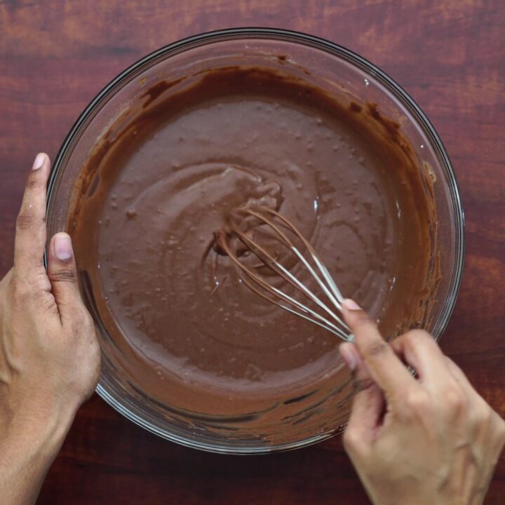 adding cocoa powder and whisking