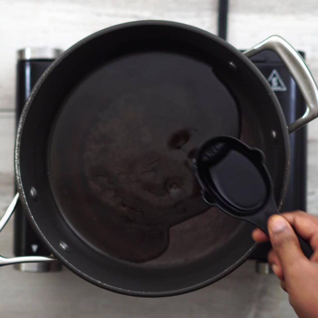 adding oil in hot pan