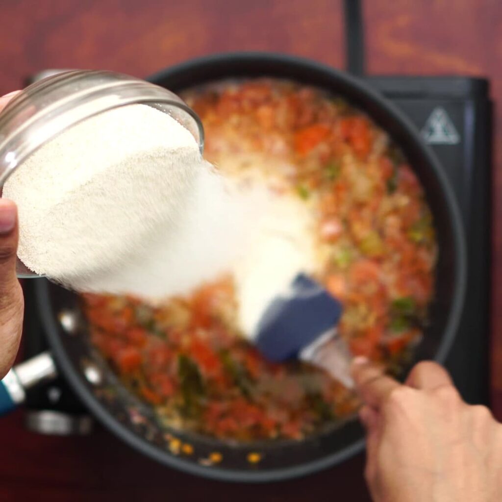 Adding Rava in batches by stirring