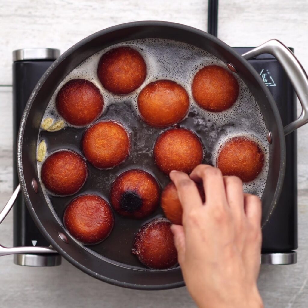 Fried Jamun is added into the syrup