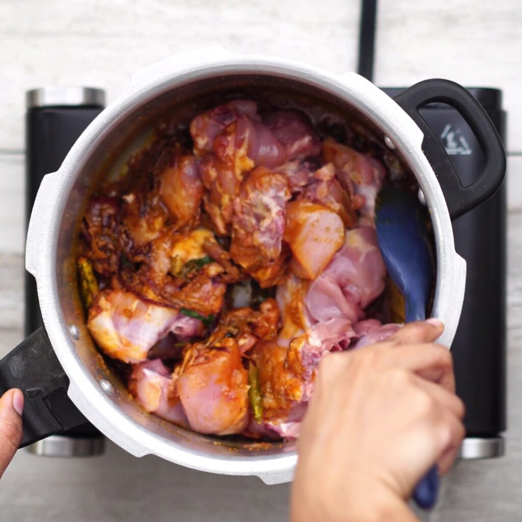 adding chicken and mixing