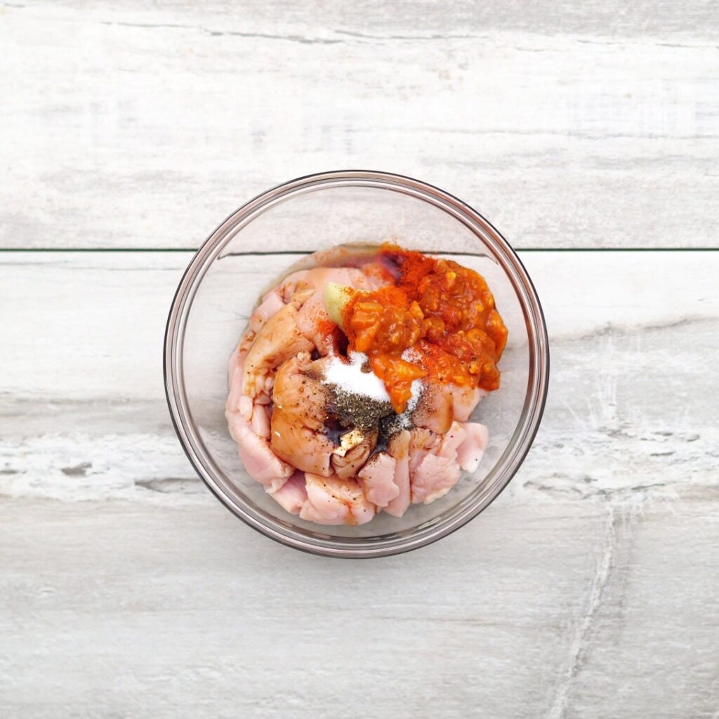 adding chicken and ingredients for marination