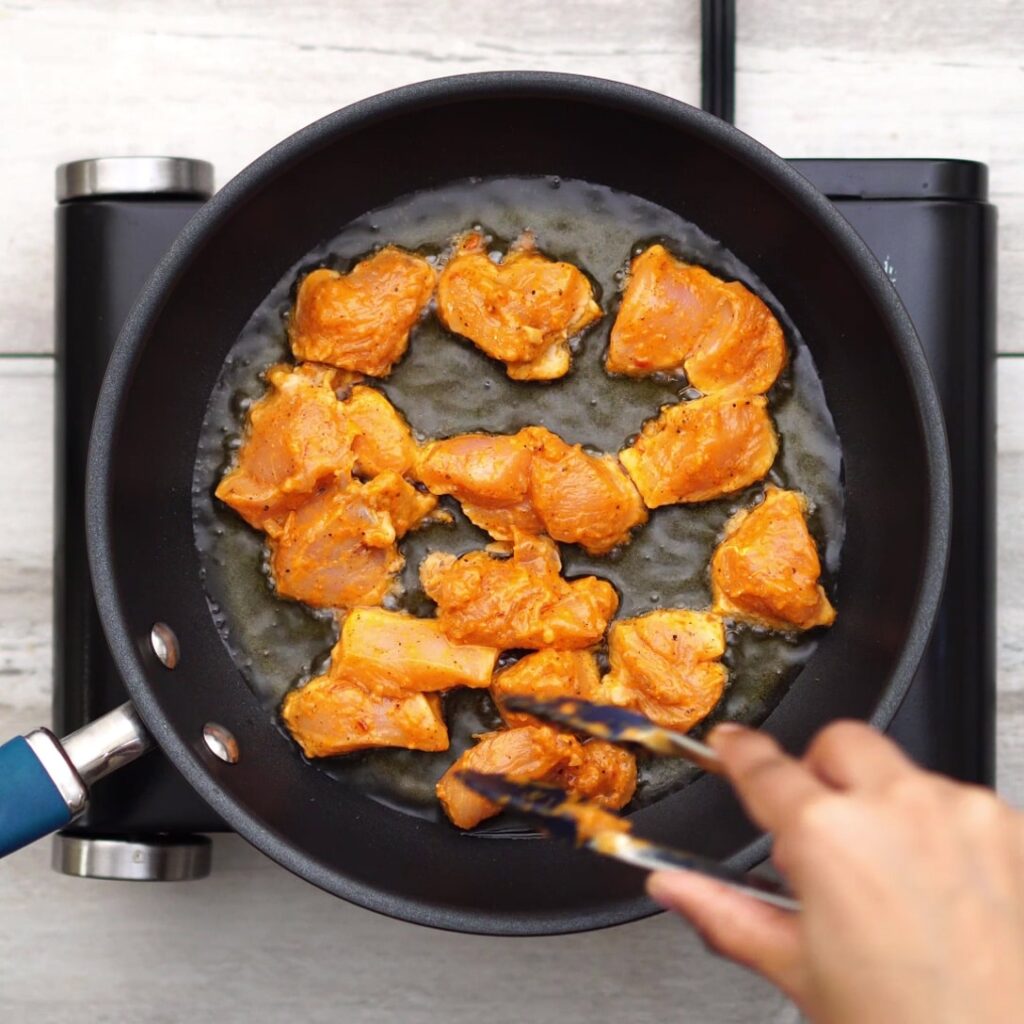 adding chicken in hot oil