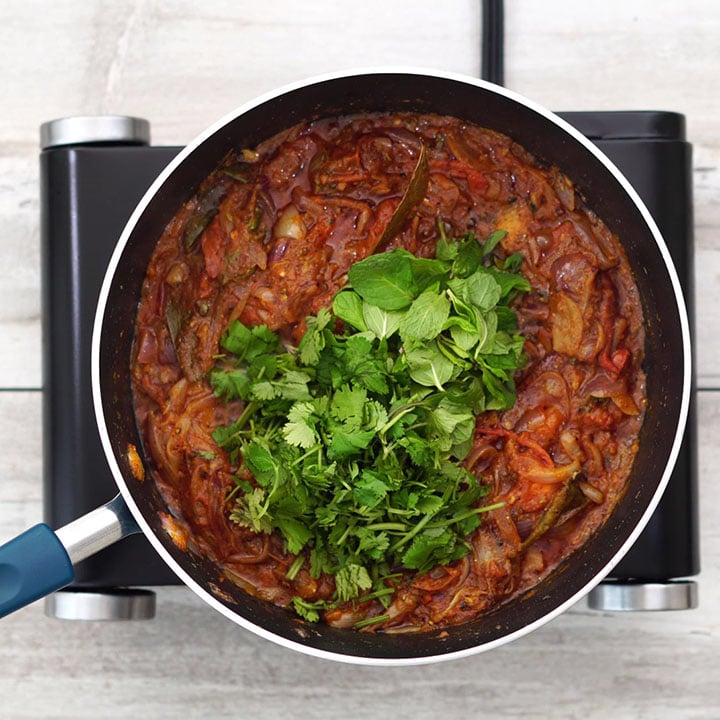 Adding mint and coriander leaves