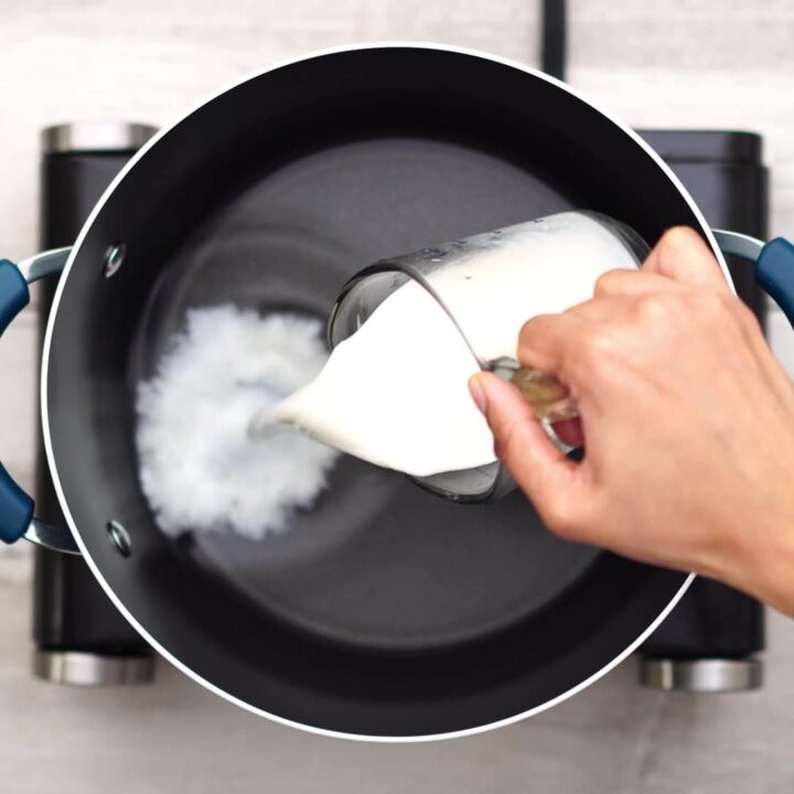 Adding water and milk in a pan