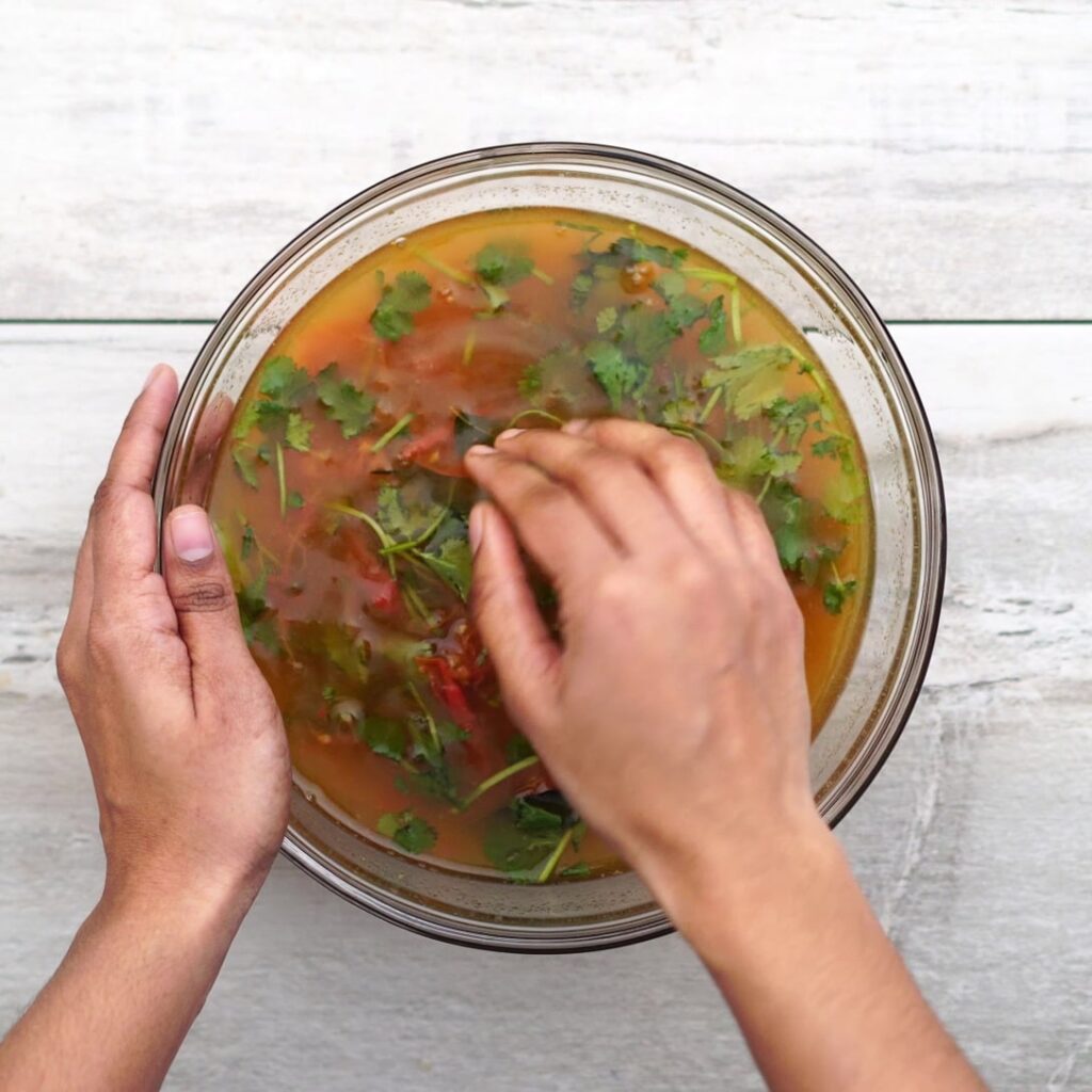 Mashing tomato with other ingredients