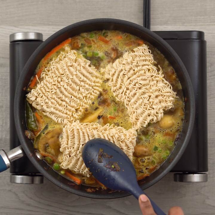 Adding the maggi noodles cube