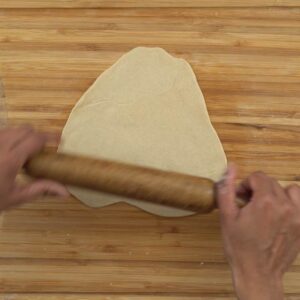 rolling the dough for chapati, triangle shape