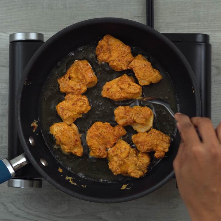 Fliping and frying the chicken pieces