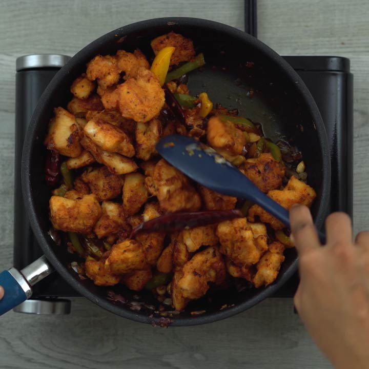 Mixing in the fried chicken