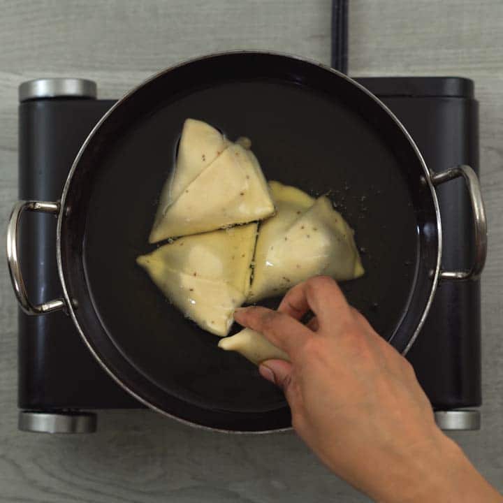 frying samosa in oil at low heat