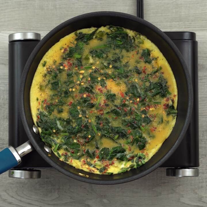 cooking of Spinach omelette mixture in a pan