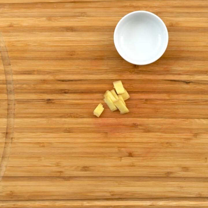 Chopped ginger placed on cutting board for making strawberry juice.