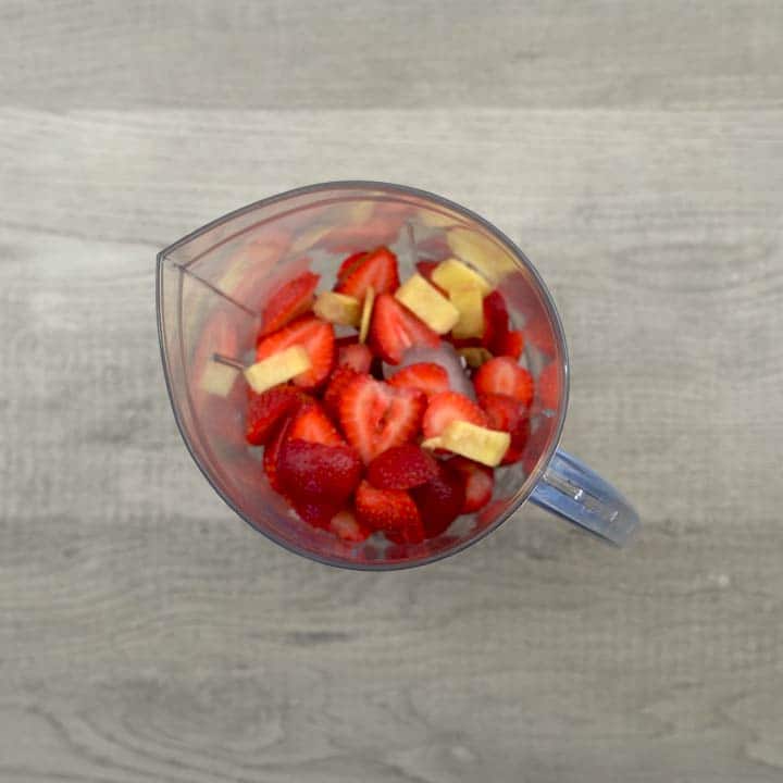 Ingredients added for strawberry juice in blender.