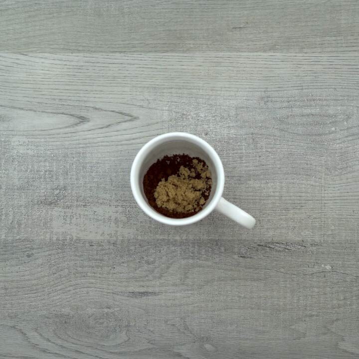 Coffee powder and brown sugar in coffee mug.