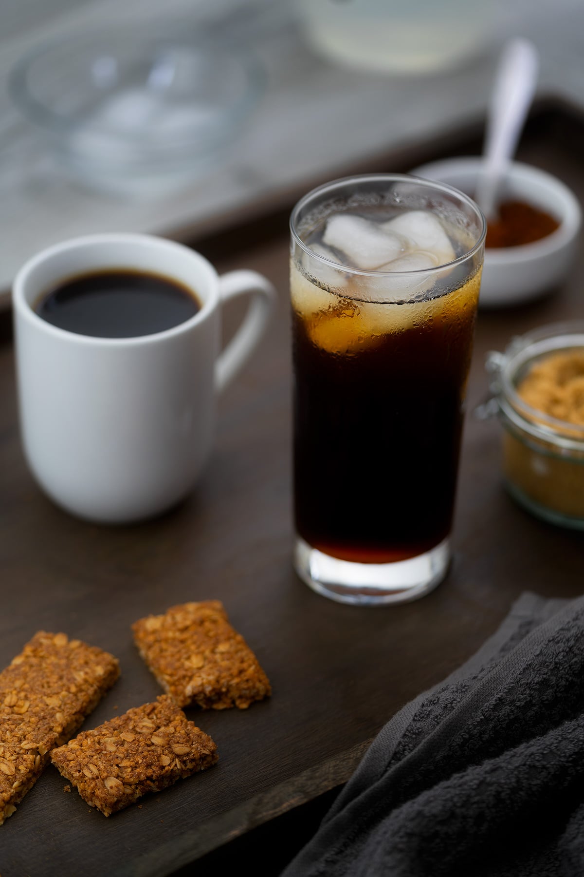 Hot and Iced Black Coffee served in a glass and coffee cup.
