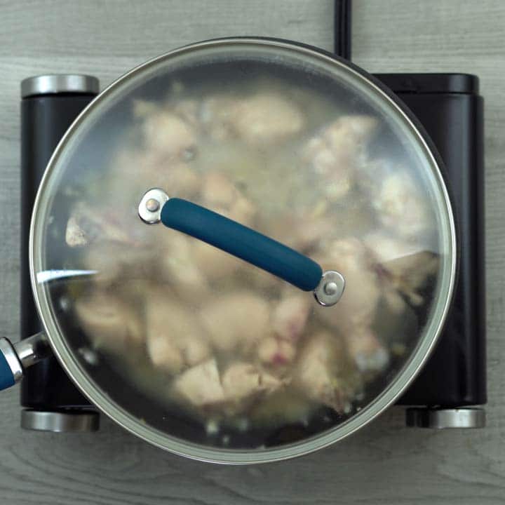 chicken cooking in the pan with lid closed