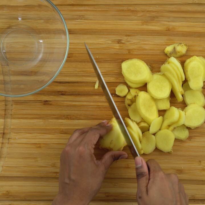 chopping fresh ginger into medium size pieces