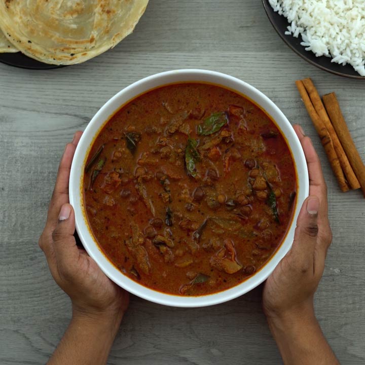 serving kerala kadala curry with parotta and rice