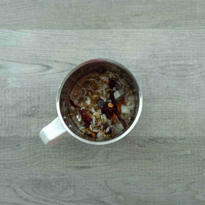 roasted spices and coconut in blender jar