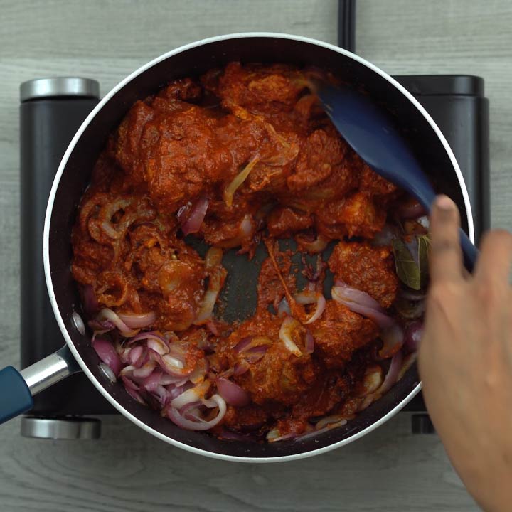 stirring in the marinated lamb pieces