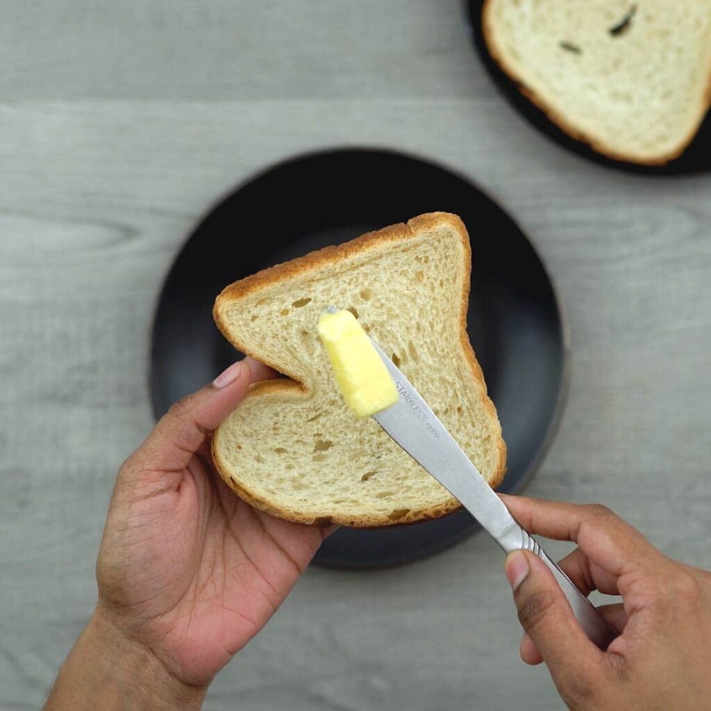 spreading butter on bread