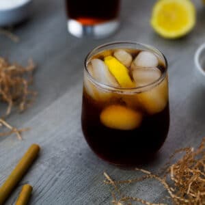 Iced Tea served in a glass with ice cubes and lemon slice.