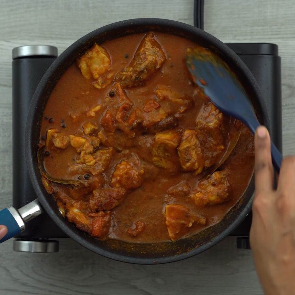 Stirring in the lamb curry