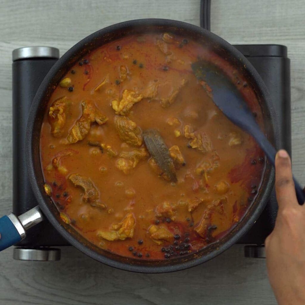stirring the lamb curry