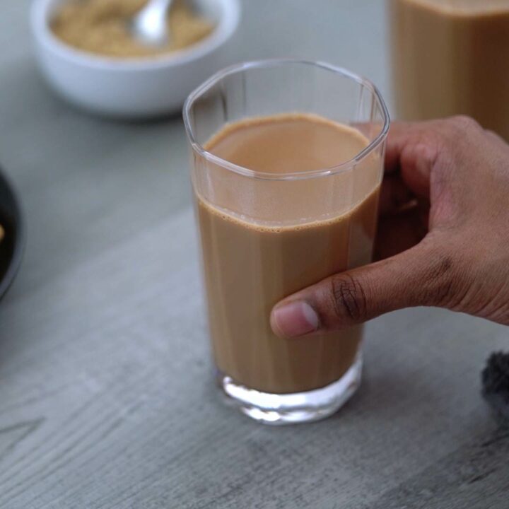 Serving the masala tea in a serving glass.