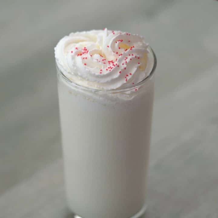 Milkshake topped with whipped cream and sprinkles.