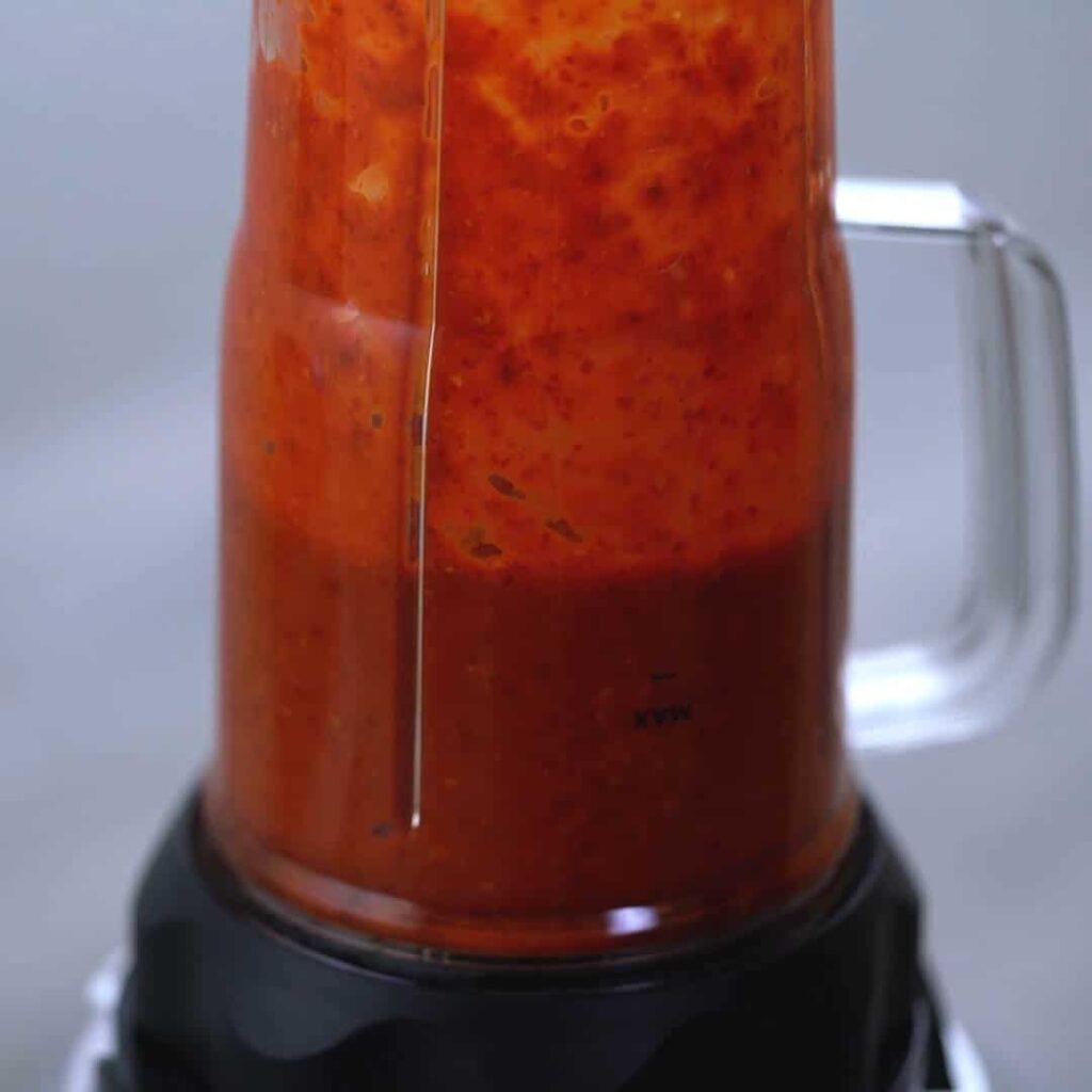 grinding red chilies in blender