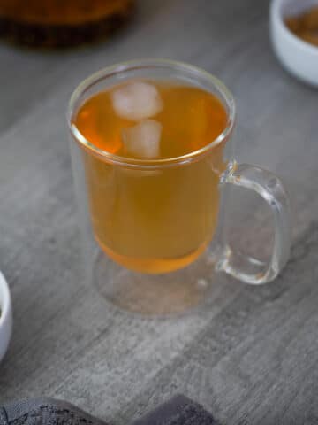 Barley Tea served with ice cubes with roasted barley kernels near by.