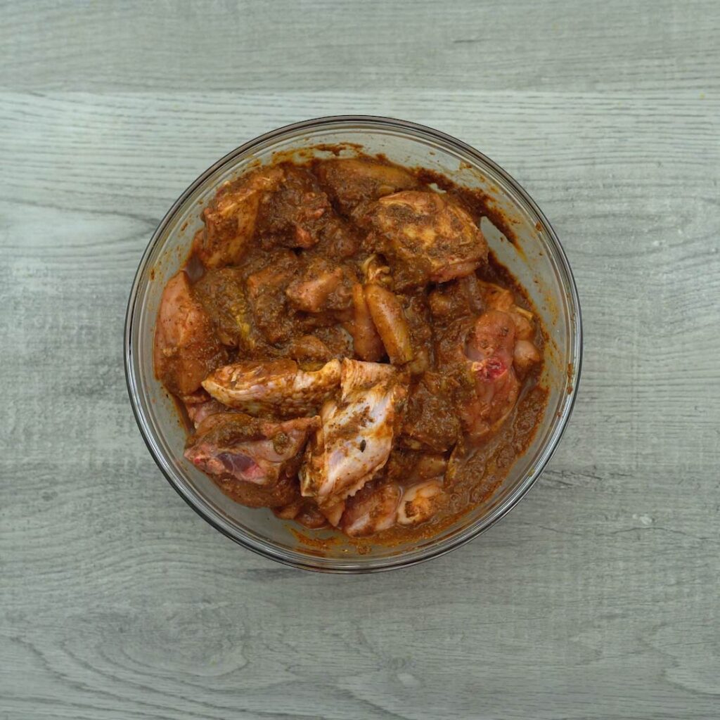 Resting the marinated chicken in a bowl