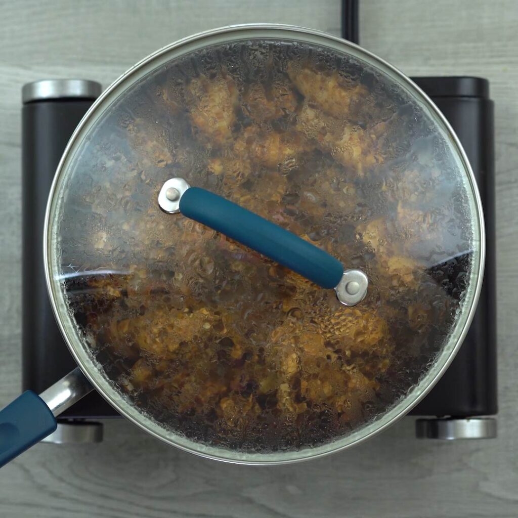 chicken cooking with lid closed