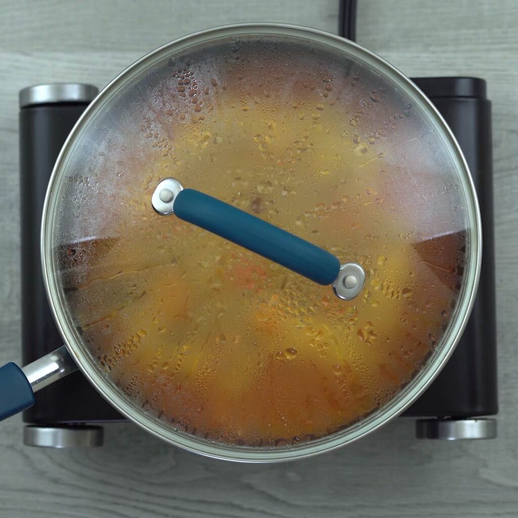 The curry is cooking with lid closed