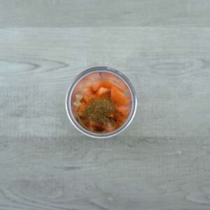 onion, tomatoes and spice powders in a blender