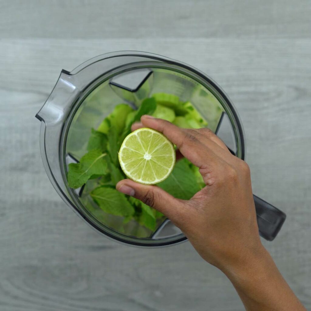 Adding lime juice to cucumber and mint leaves.