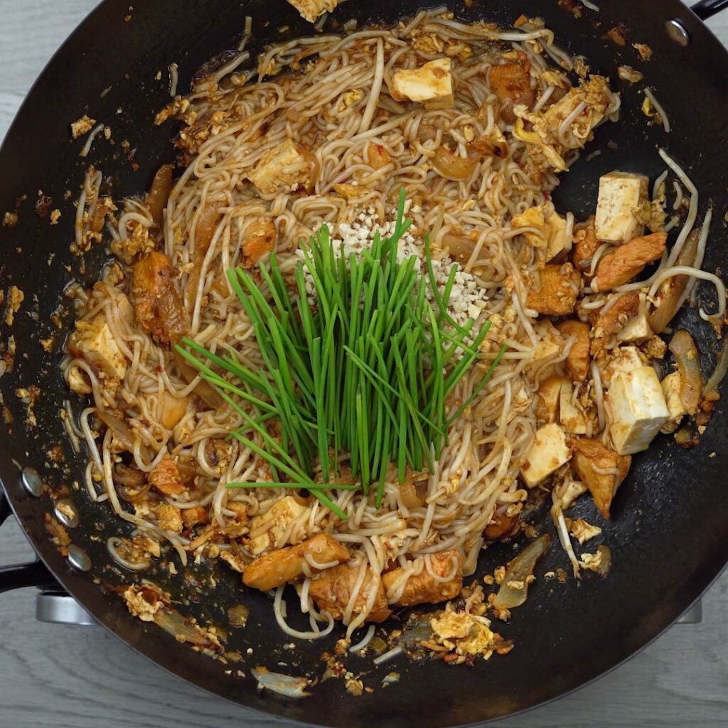 chives and peanuts to the noodles mix