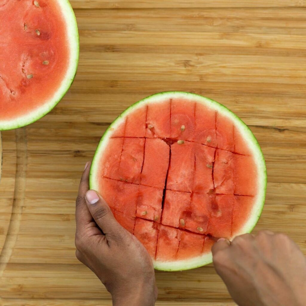 Cutting watermelon into small pieces.
