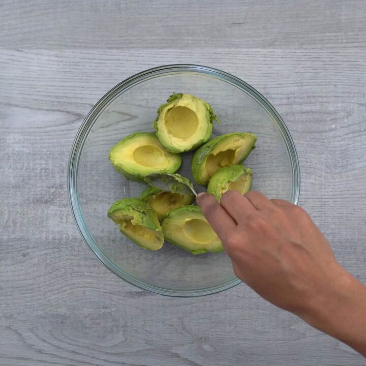 adding scooped avocado to bowl