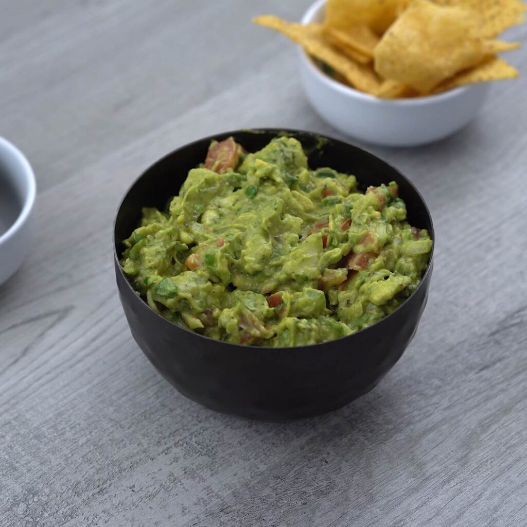 authentic Mexican Guacamole is served with tortilla chips