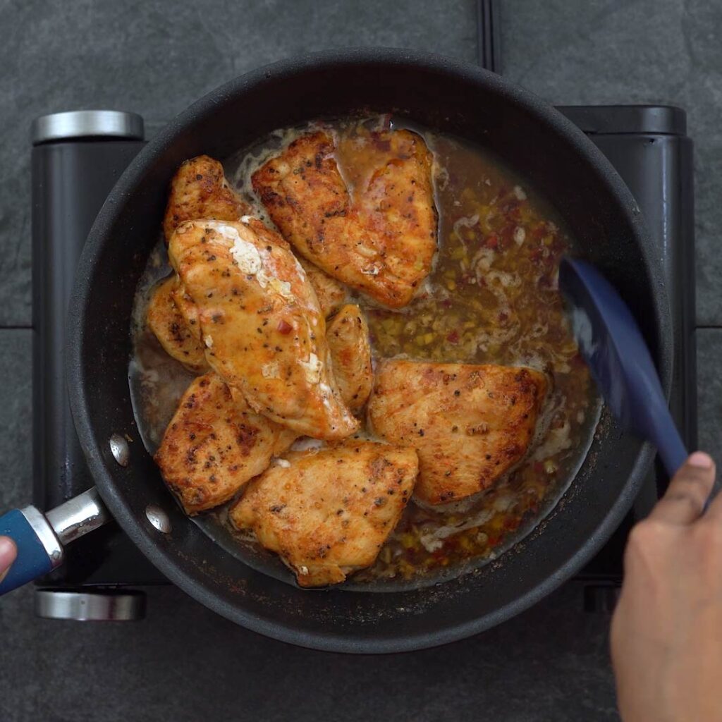stirring in the chicken to the sauce