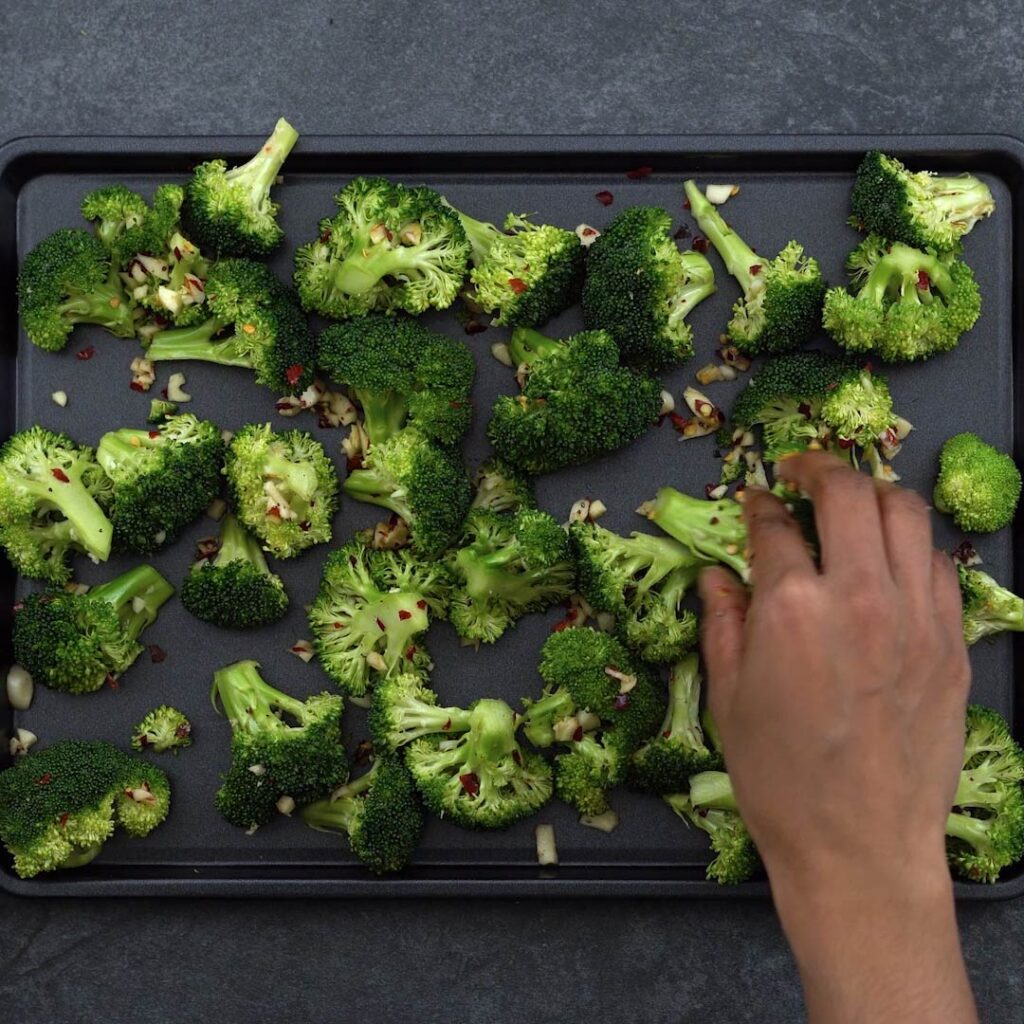Spreading broccoli in baking sheet