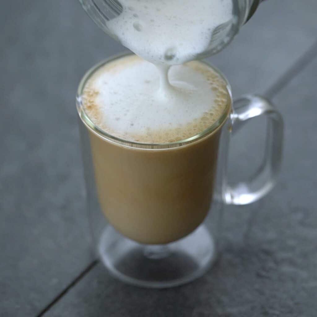 Pouring frothed milk.