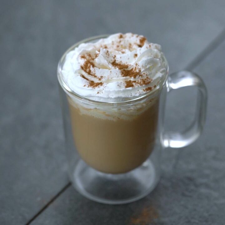Chai tea latte with whipped cream topped.
