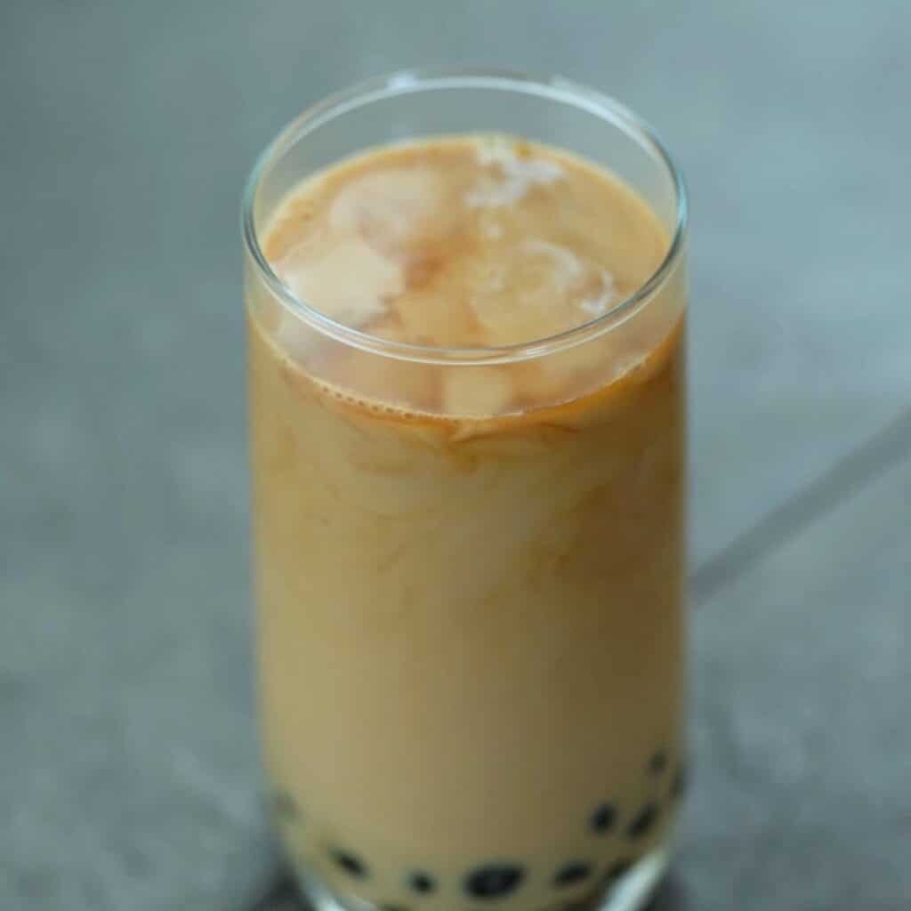 Bubble tea or Boba Milk tea is served in a glass.