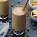 Bubble Tea served in a glass with brown sugar placed in a bowl.