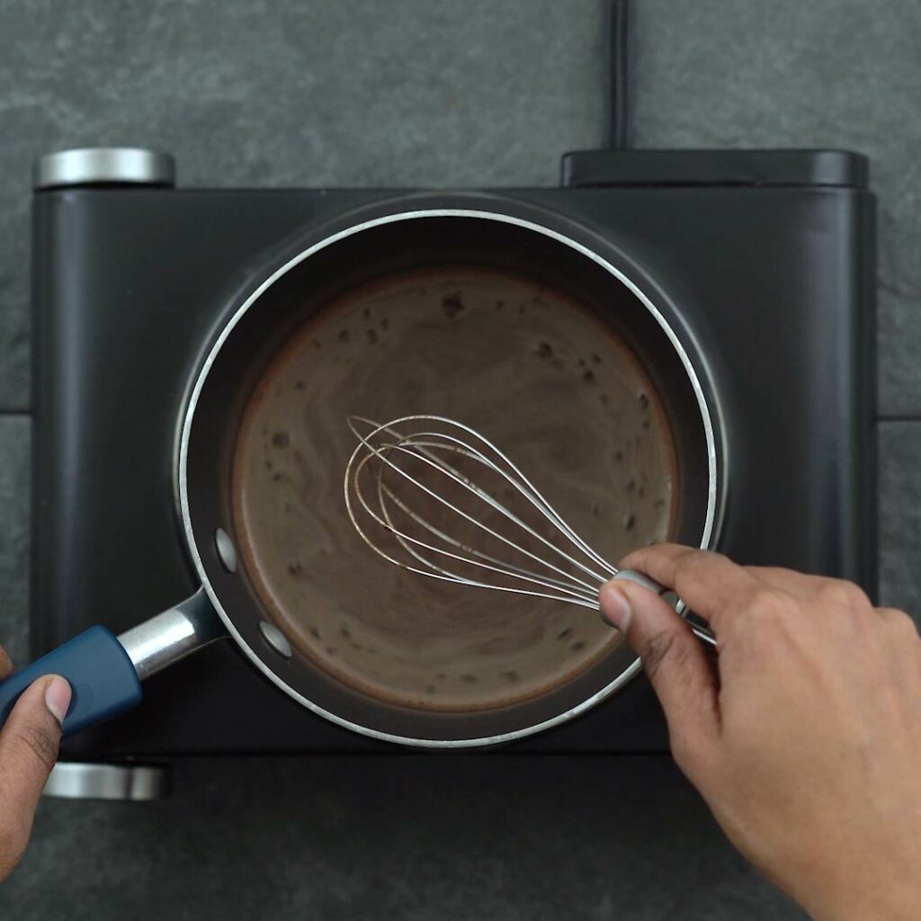 Whisking the hot chocolate.